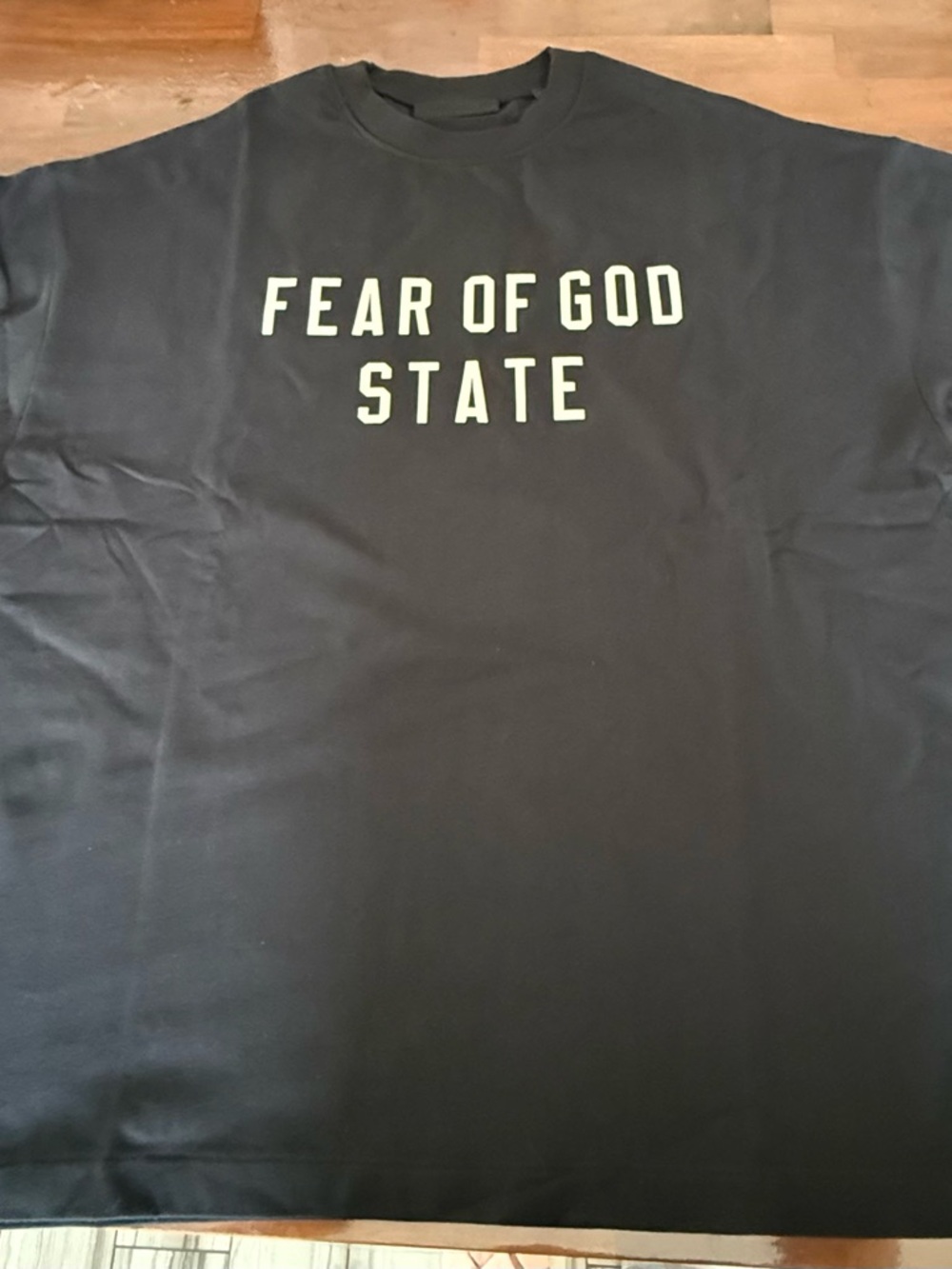 Fear of God Essential Black Graphic Tee with Cream Print